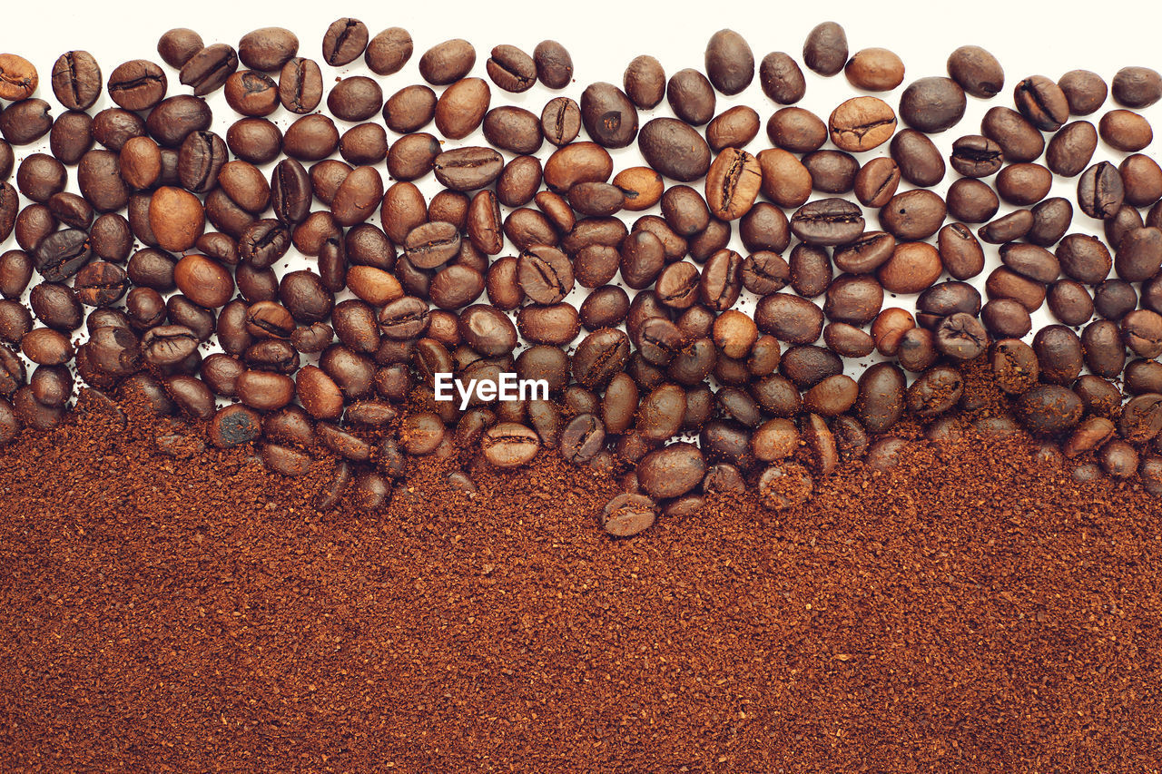 Close-up of roasted coffee beans on white background