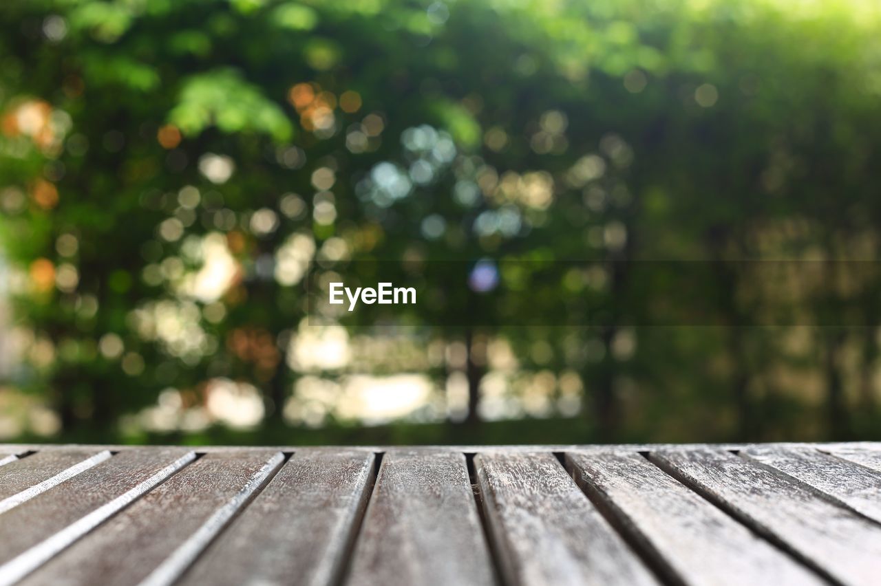 Wood plank deck for copy space. wood board for products placement and bokeh light background.