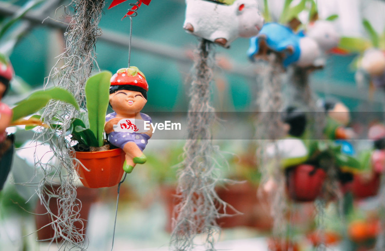 Close-up of figurine hanging outdoors