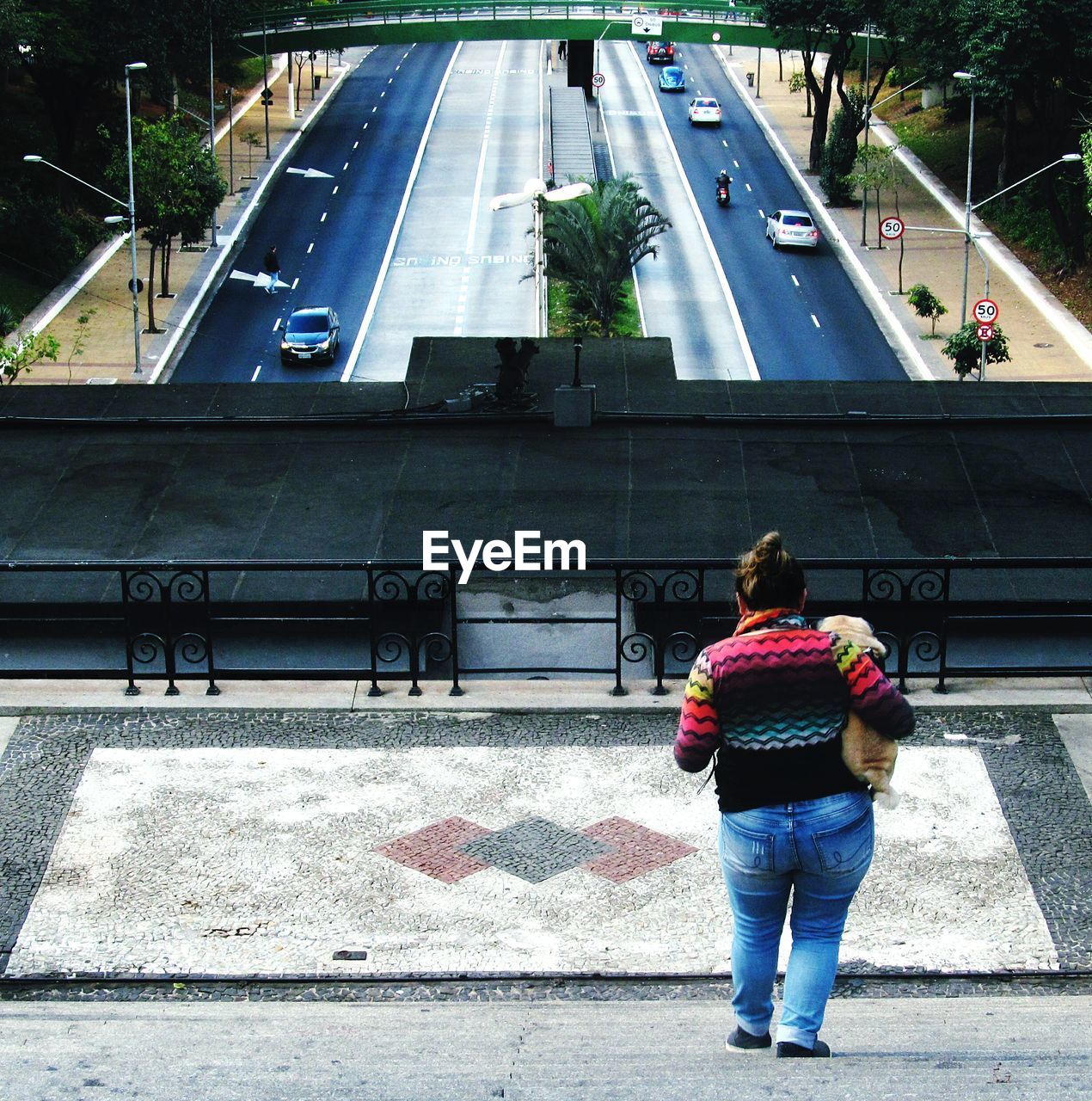 FULL LENGTH REAR VIEW OF WOMAN STANDING ON ROAD