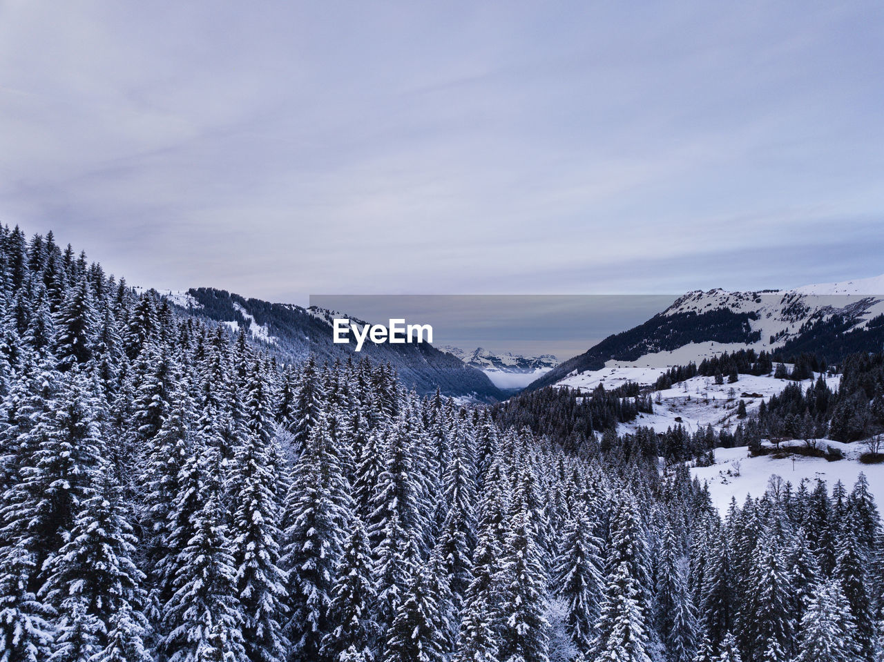 Scenic view of snow covered mountains against sky