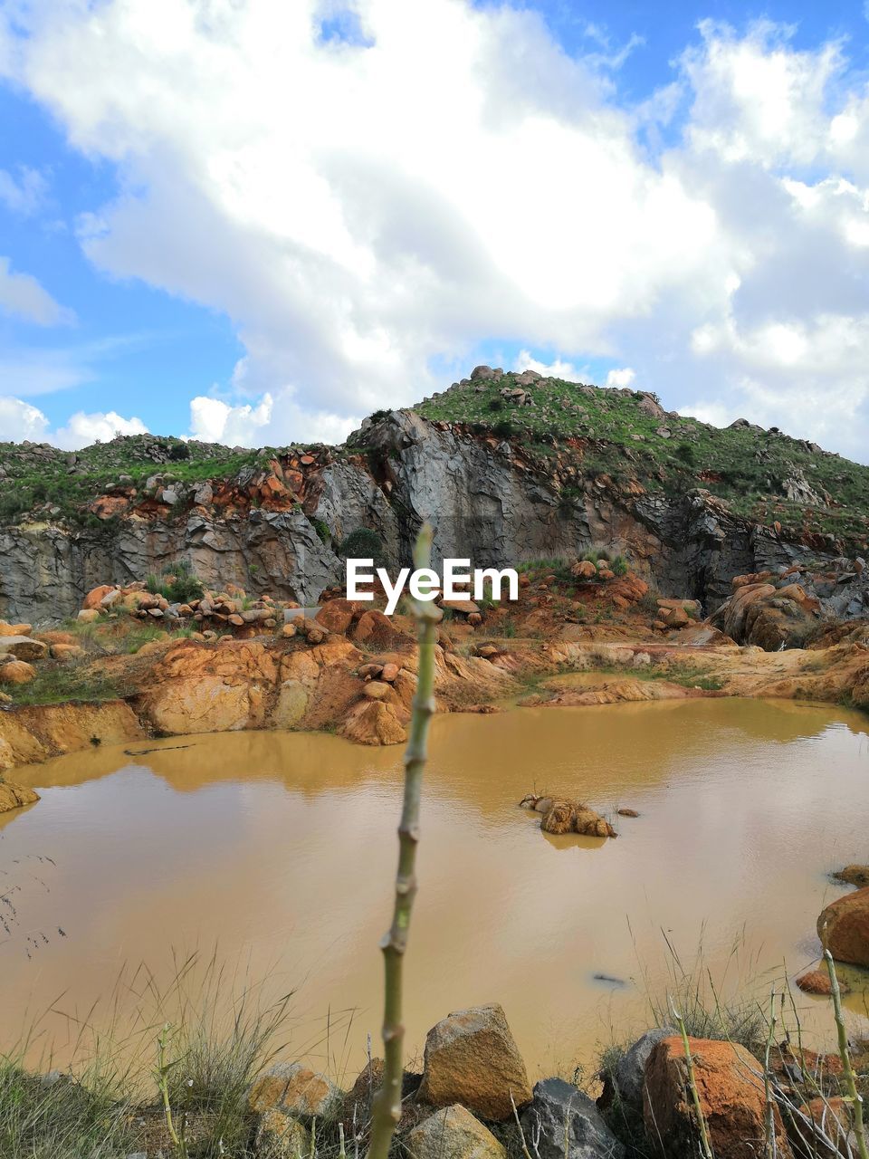 SCENIC VIEW OF ROCKS ON LANDSCAPE AGAINST SKY