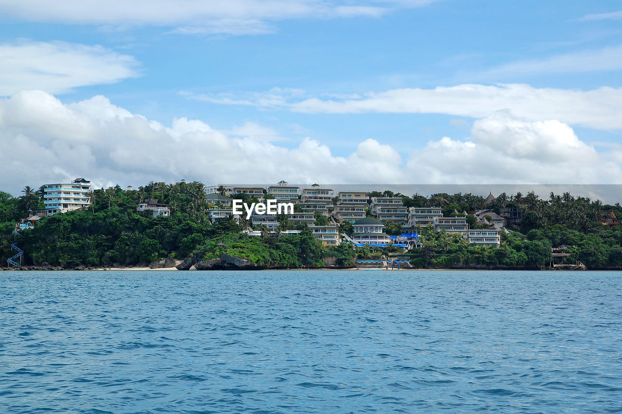 BUILDINGS AND SEA AGAINST SKY