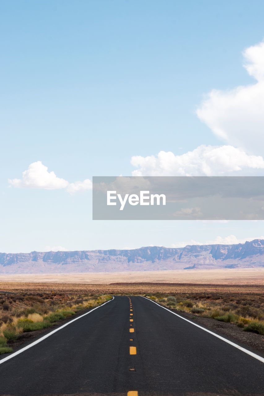 Road passing through landscape against sky