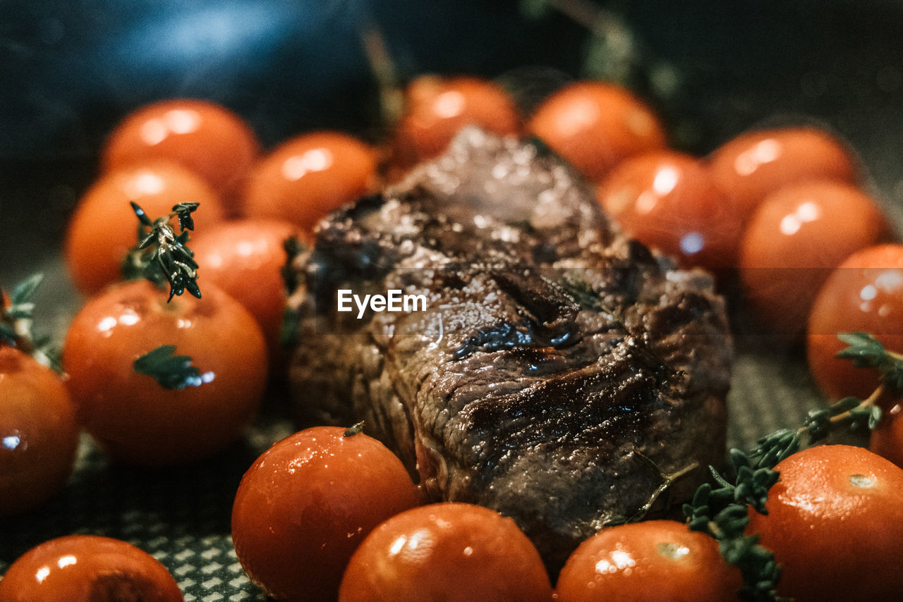 Close-up of meat and tomatoes while cooking