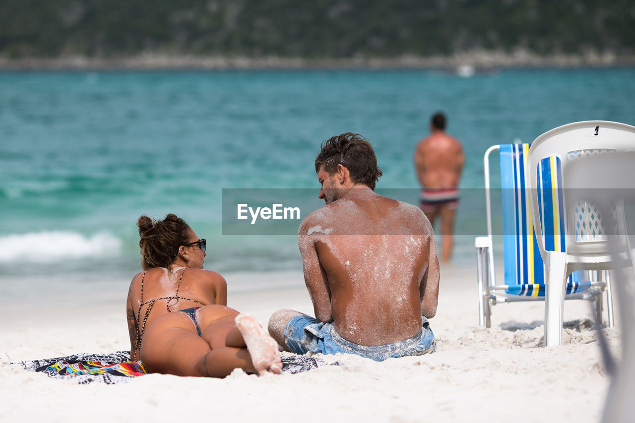 FRIENDS RELAXING ON BEACH