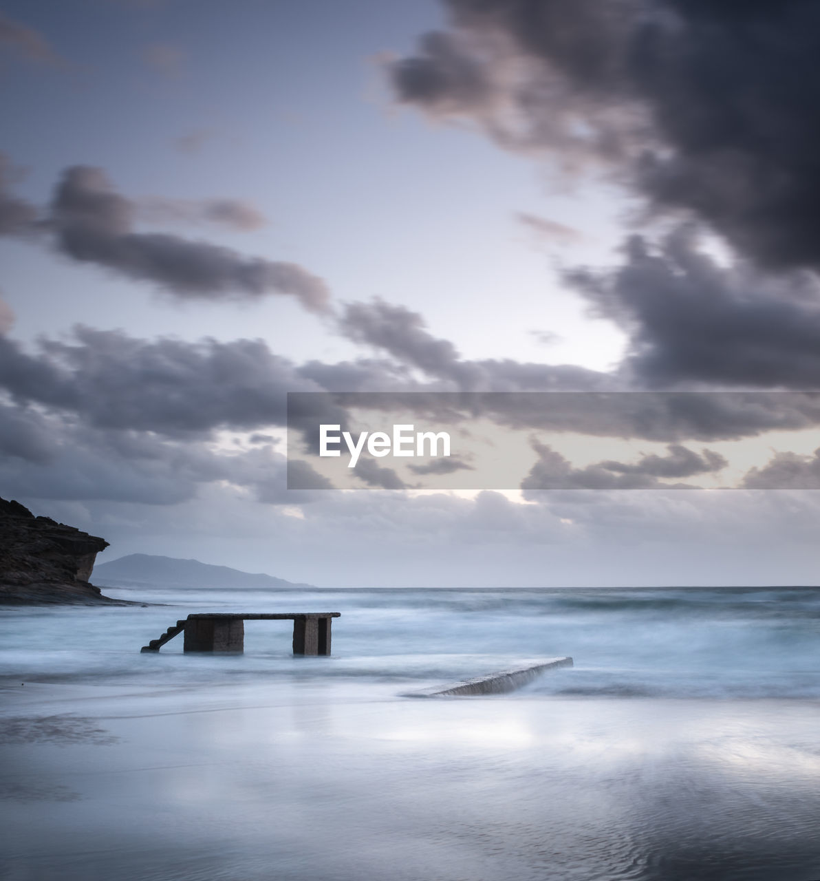 Cloudy sunset over funtanazza seashore in sardinia