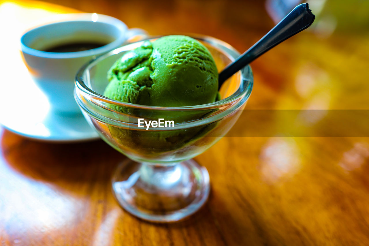 Close-up of green tea ice cream in glass on table