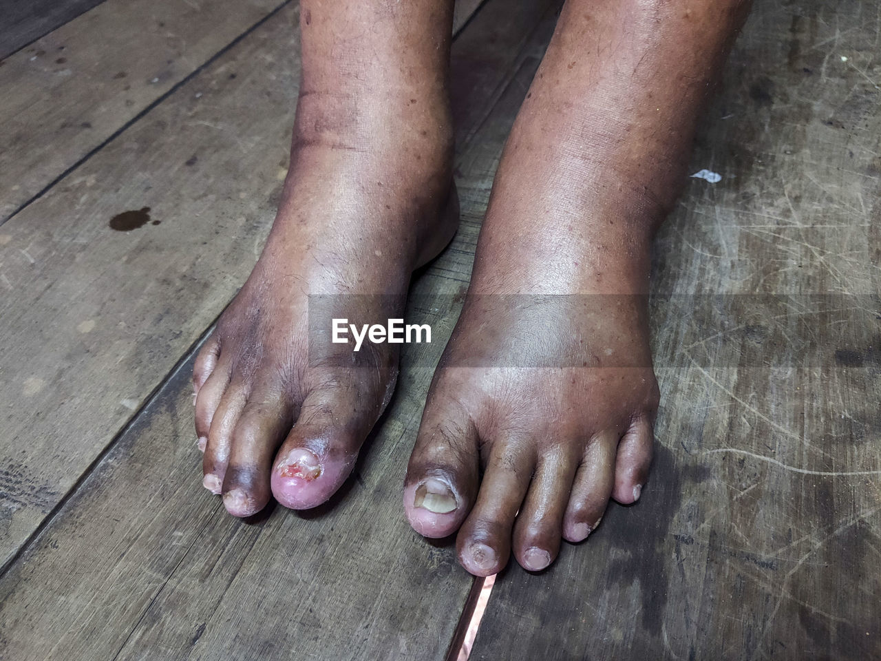 LOW SECTION OF MAN ON HARDWOOD FLOOR