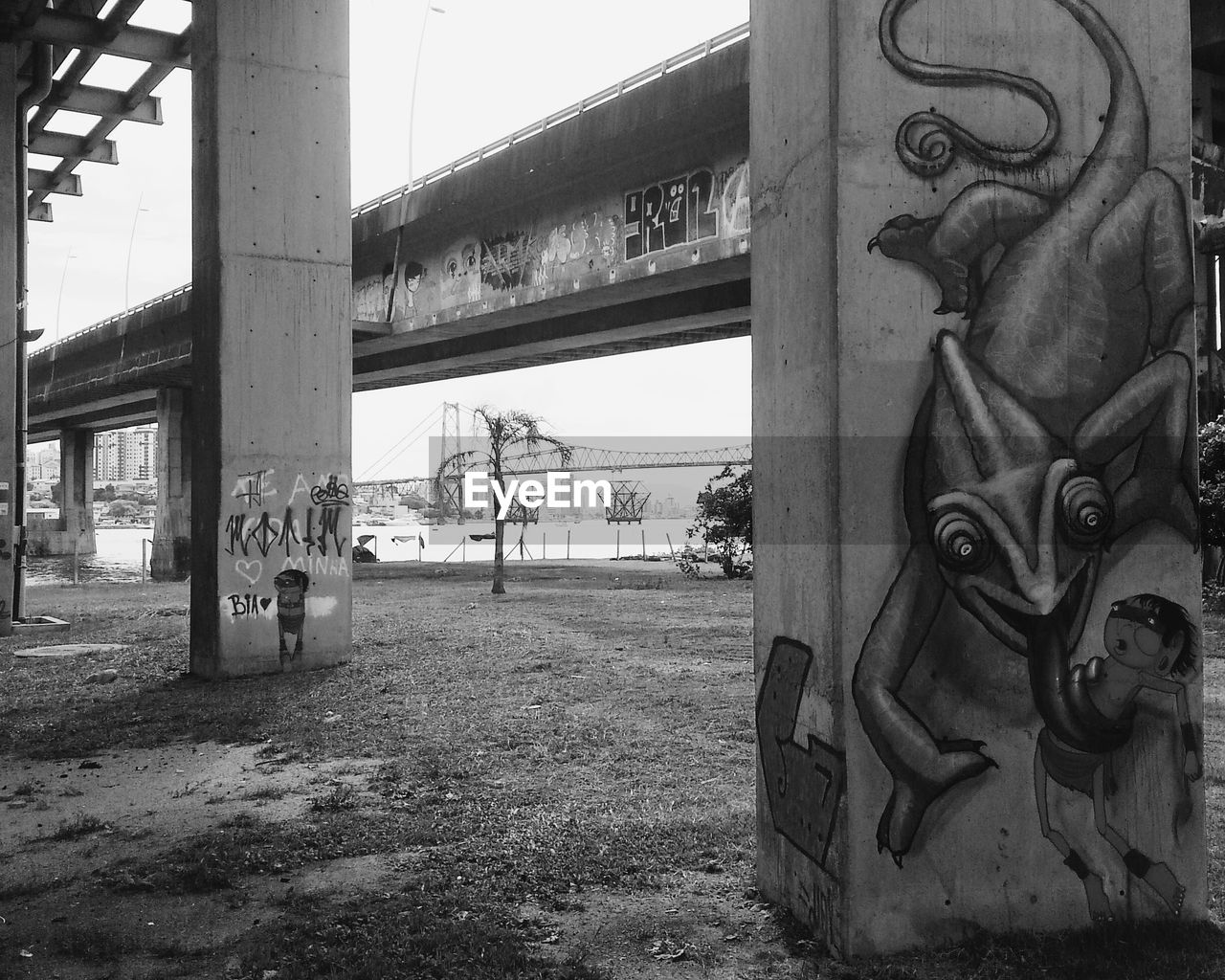 Graffiti on bridge column against sky
