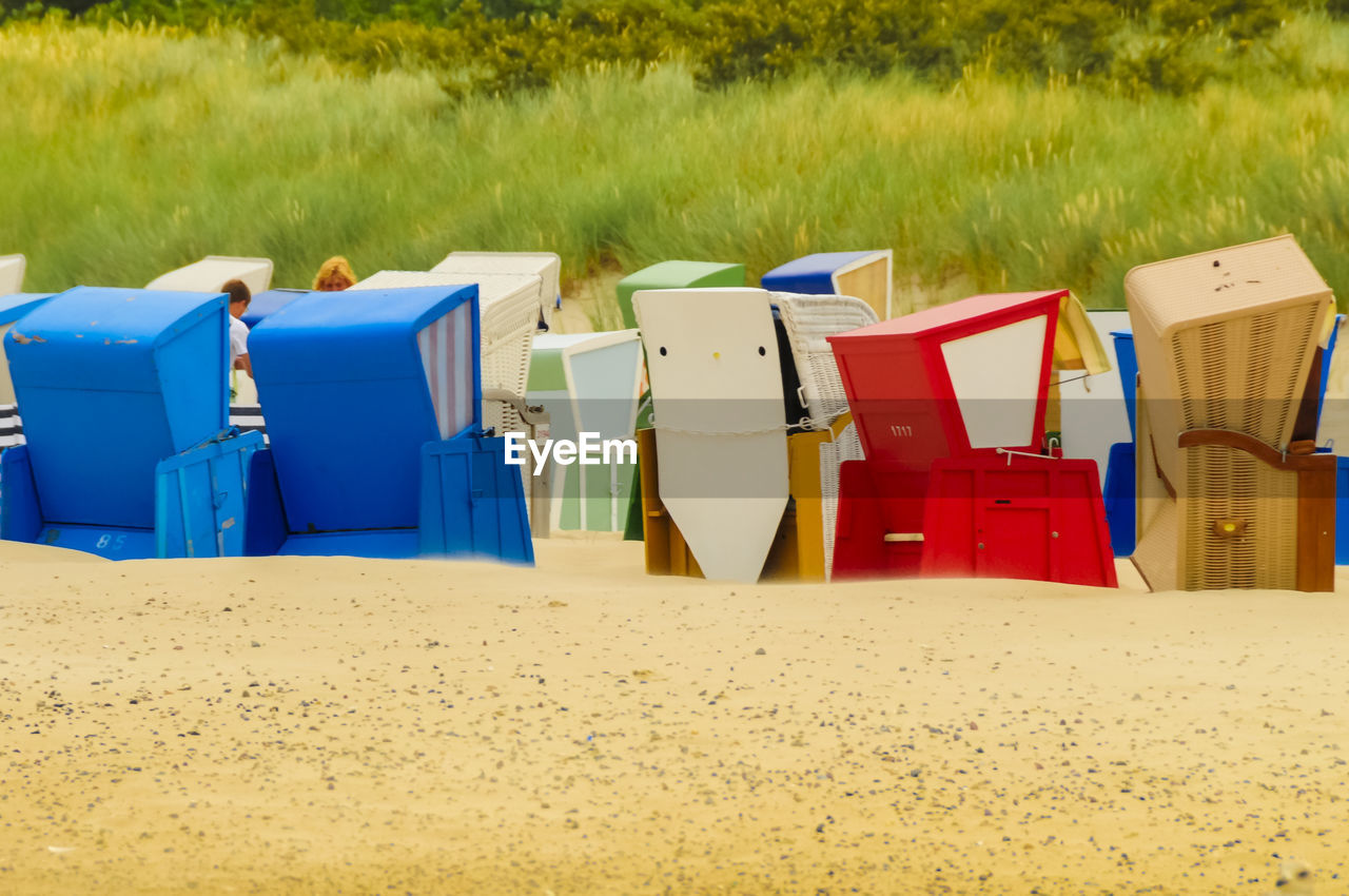 Multi colored chairs on sand at beach