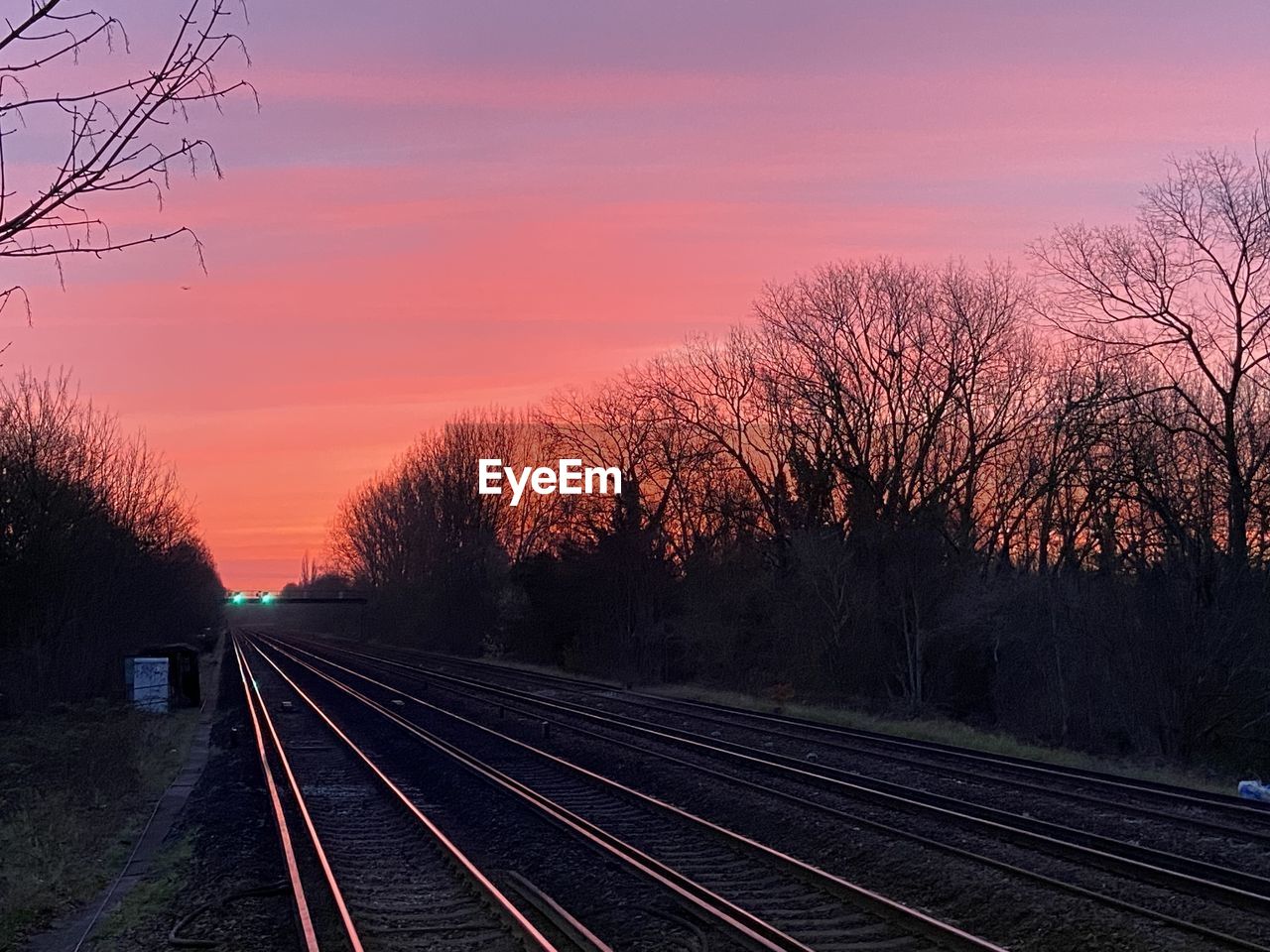 morning, track, rail transportation, railroad track, sky, transportation, tree, nature, plant, dusk, sunrise, bare tree, mode of transportation, no people, travel, beauty in nature, the way forward, outdoors, railway, train, cloud, public transportation, tranquility, diminishing perspective, vanishing point, transport, sunlight, silhouette, landscape, scenics - nature, environment