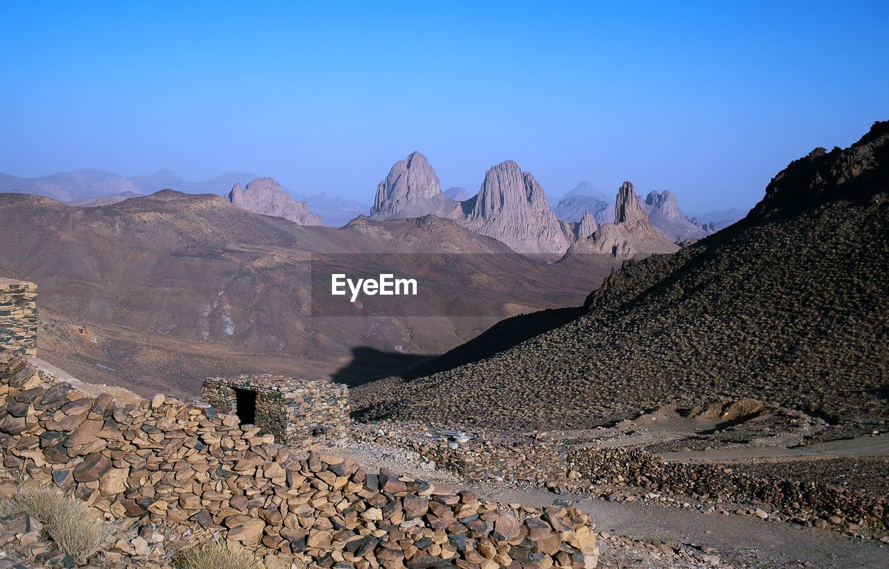 Scenic view of mountains against clear blue sky