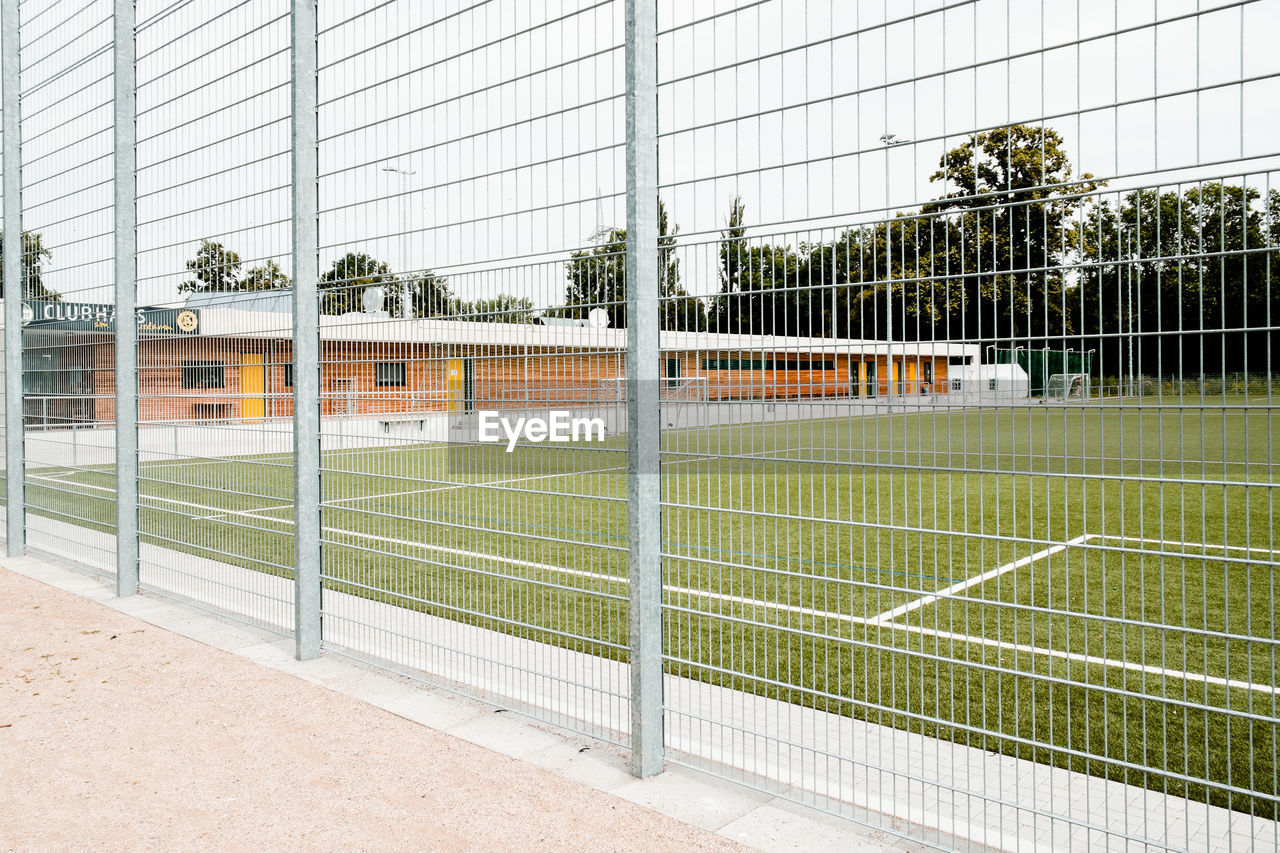 Empty soccer field seen through fence