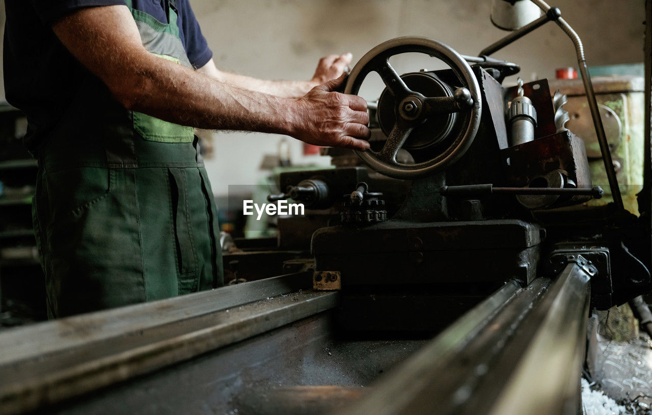 cropped image of man working at workshop