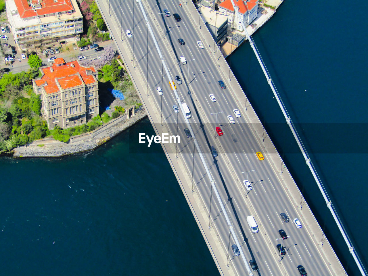 High angle view of cars moving on bridge over sea during sunny day