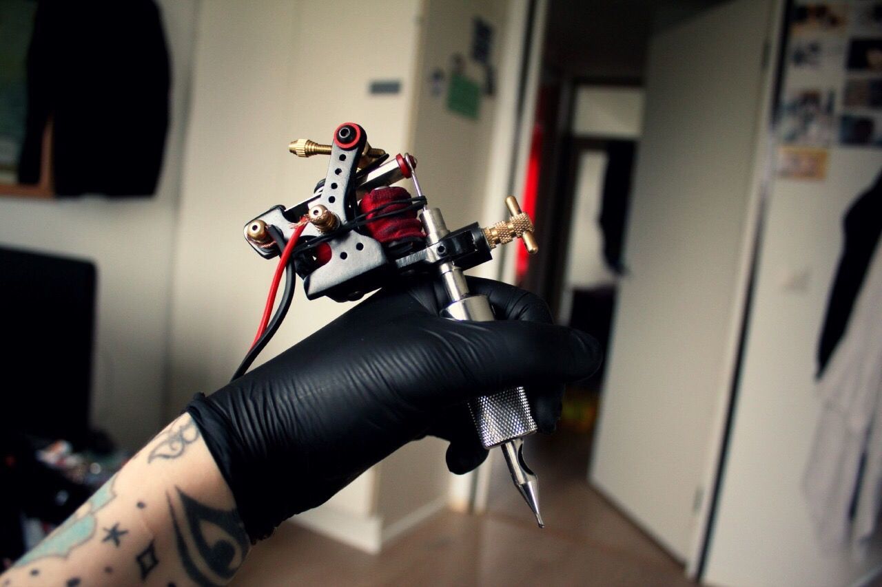 Woman with device for tattoo making