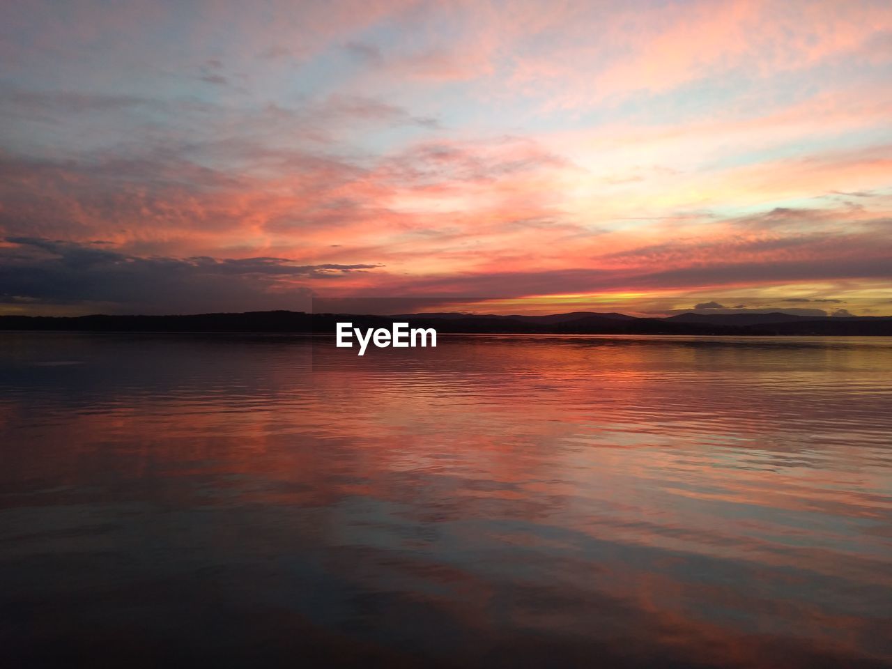 SCENIC VIEW OF SEA AGAINST ORANGE SKY