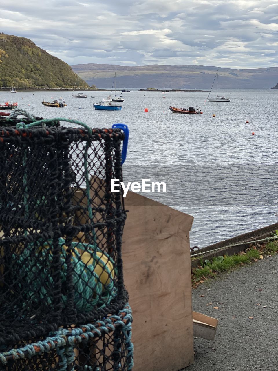 water, sea, fishing, sky, fishing industry, nature, transportation, cloud, coast, land, nautical vessel, beach, no people, day, blue, fishing net, fence, harbor, beauty in nature, outdoors, scenics - nature, tranquility, buoy, mode of transportation, environment, tranquil scene, shore, commercial fishing net, body of water, mountain, ocean, travel destinations, boat, travel
