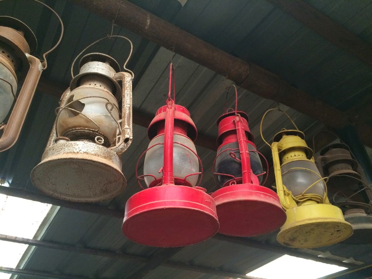 Low angle view of old lanterns hanging on roof