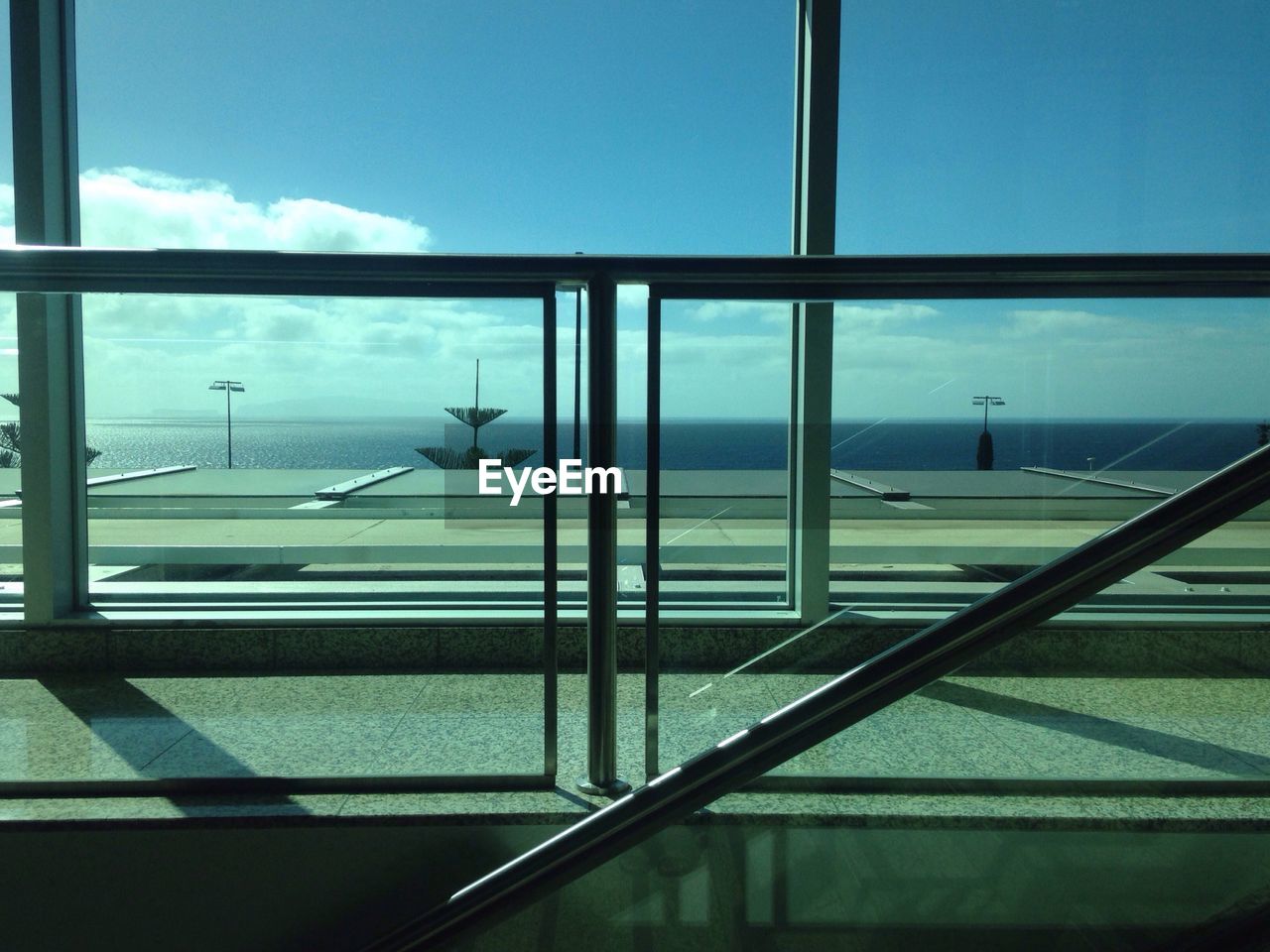 Sea seen through glass window of modern building