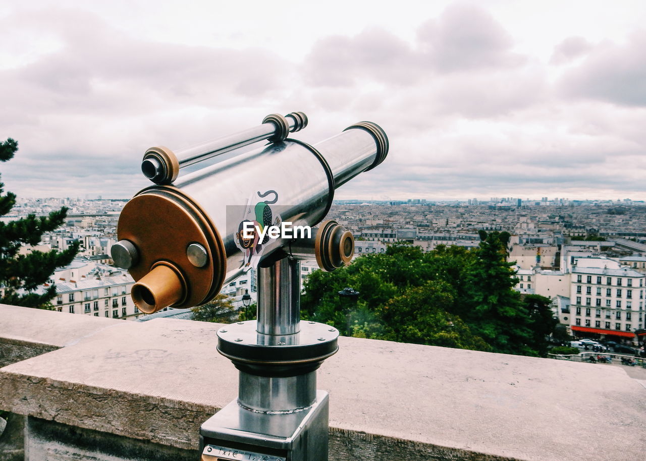 Close-up of coin-operated binoculars against sky