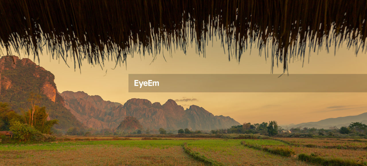 Scenic view of field against sky during sunset