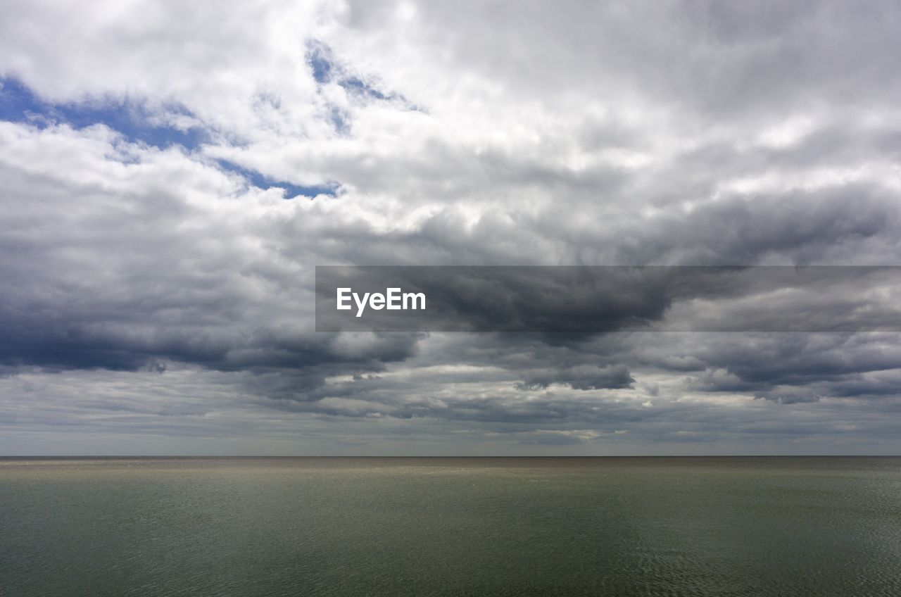 SCENIC VIEW OF CLOUDS OVER FIELD