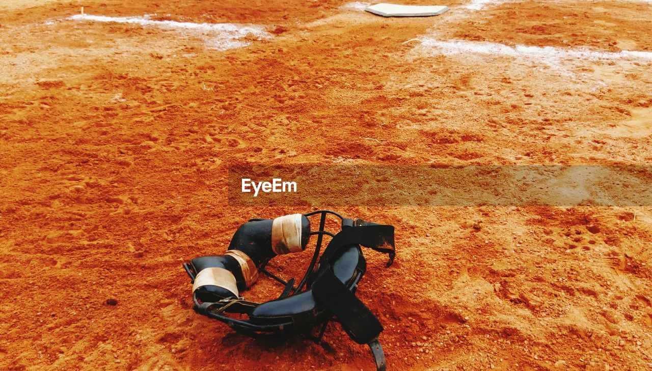 High angle view of baseball face mask on field