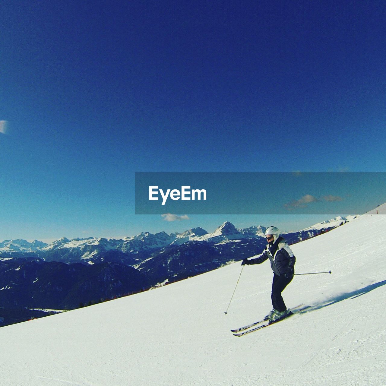 Woman skiing on snow covered mountain