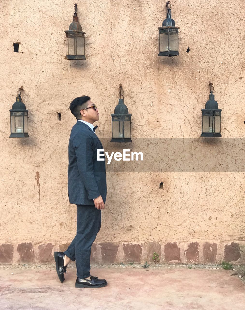 Full length of man standing against building