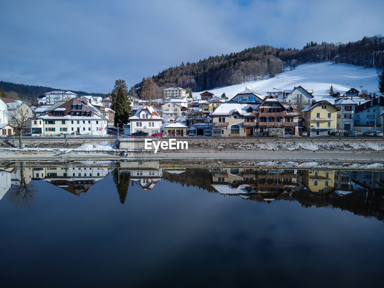 Reflection of buildings in lake against sky