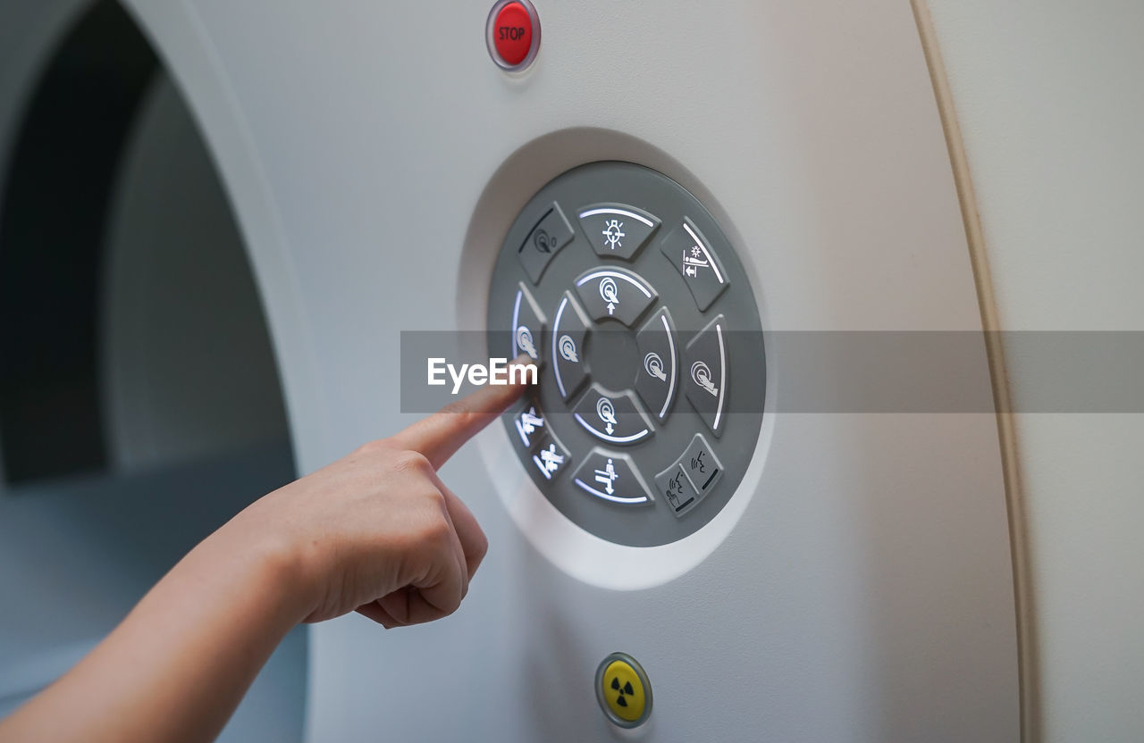 Cropped image of person pressing medical equipment button in hospital 