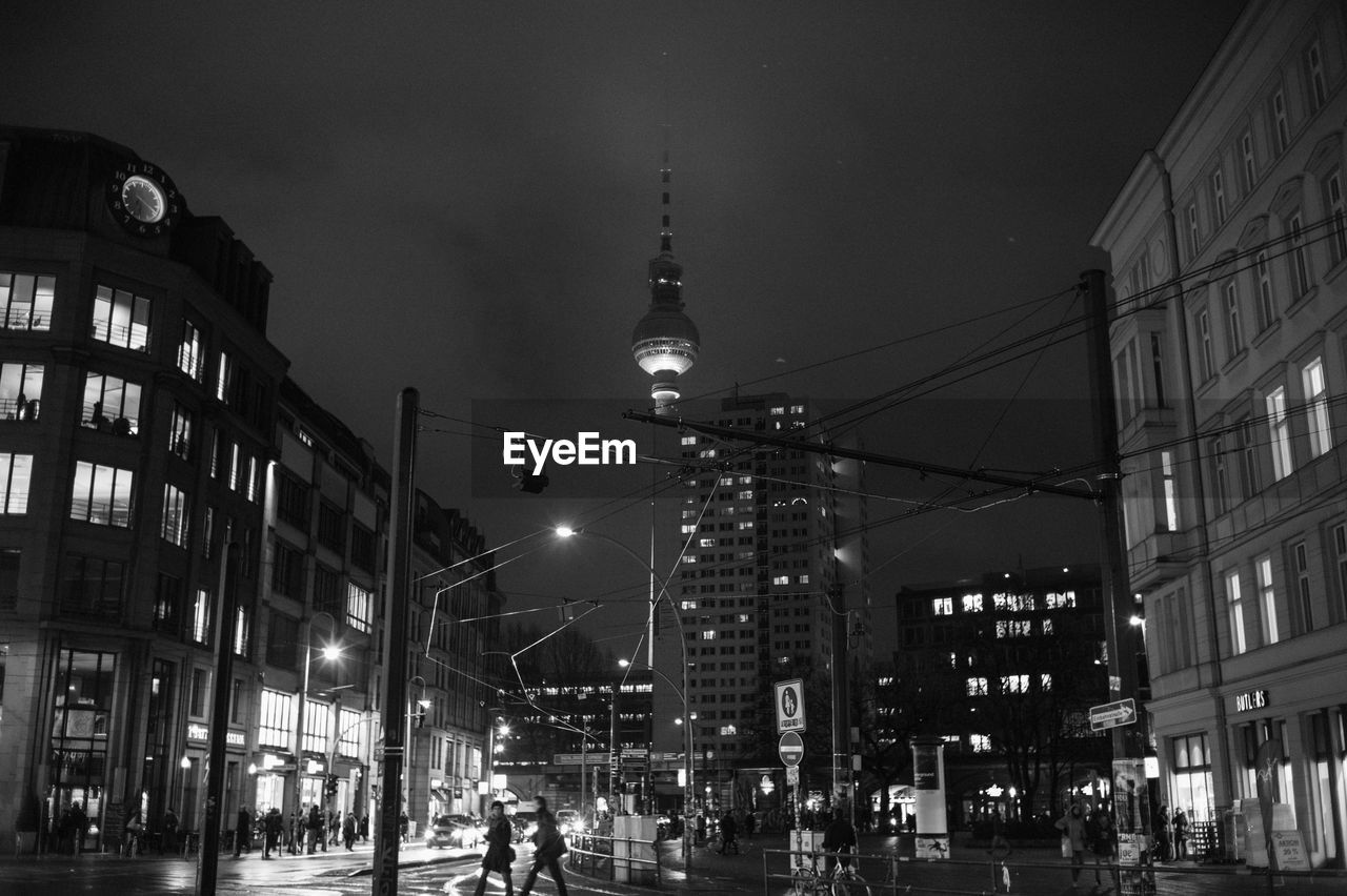 Low angle view of fernsehturm against sky in city at night