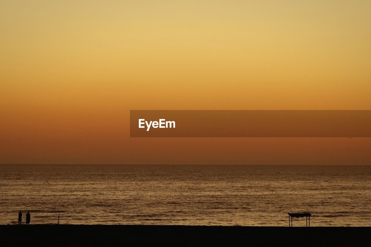 Scenic view of sea at sunset