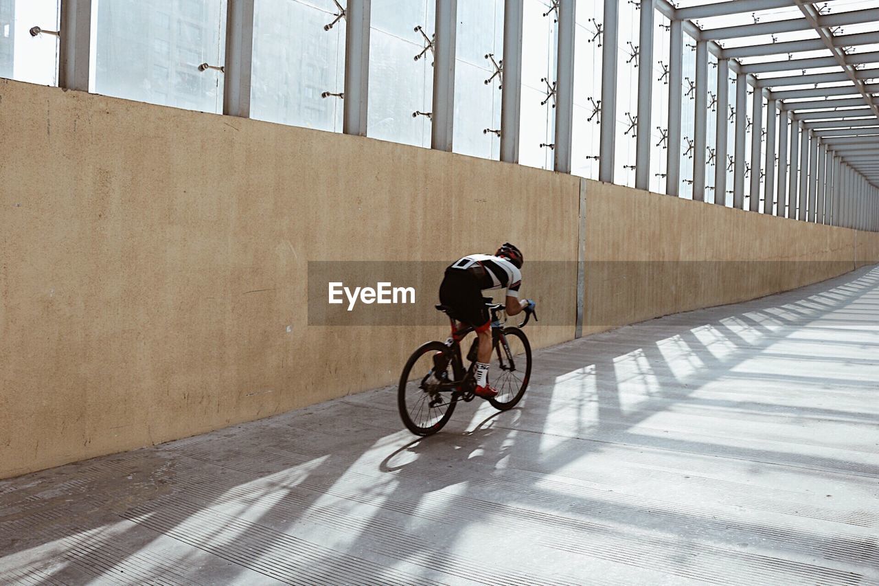 MAN CYCLING ON BICYCLE LANE