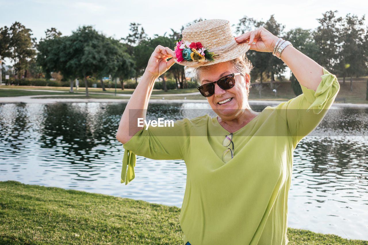 Portrait of smiling retired woman wearing a hat