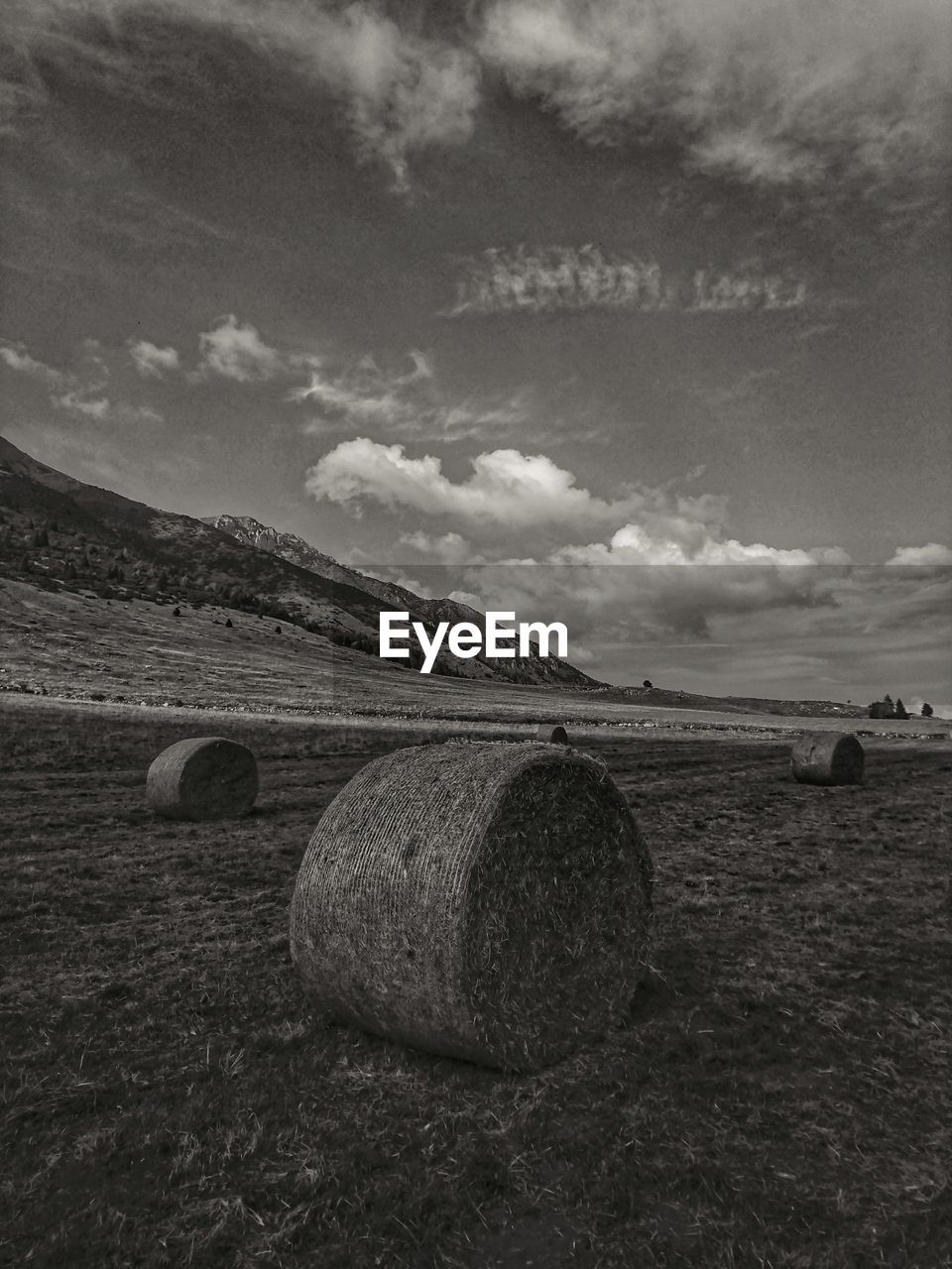 Hay bales on field against sky