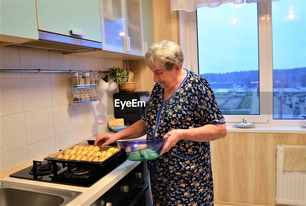 Full length of woman having food at home