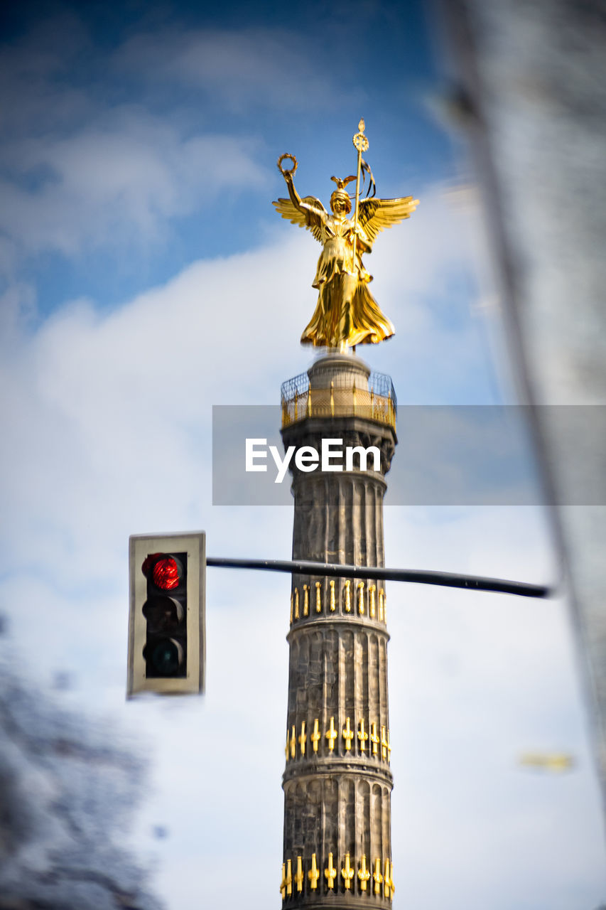 Low angle view of statue against cloudy sky