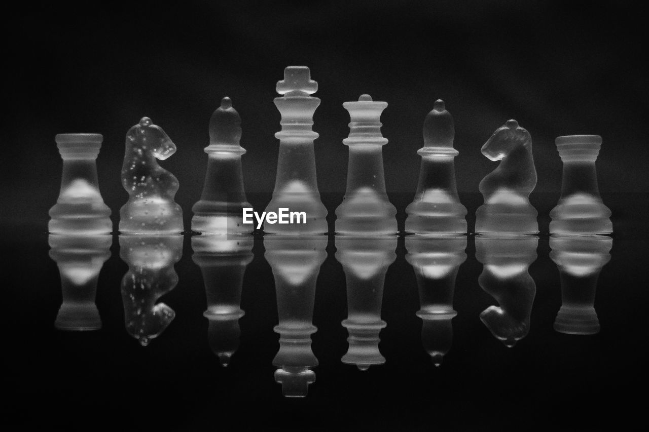 Close-up of chess pieces against black background