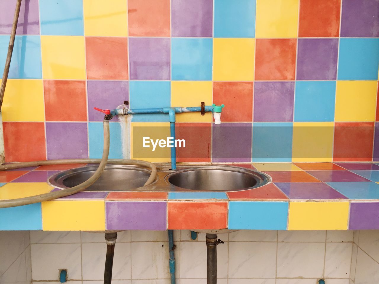 Sink against colorful wall