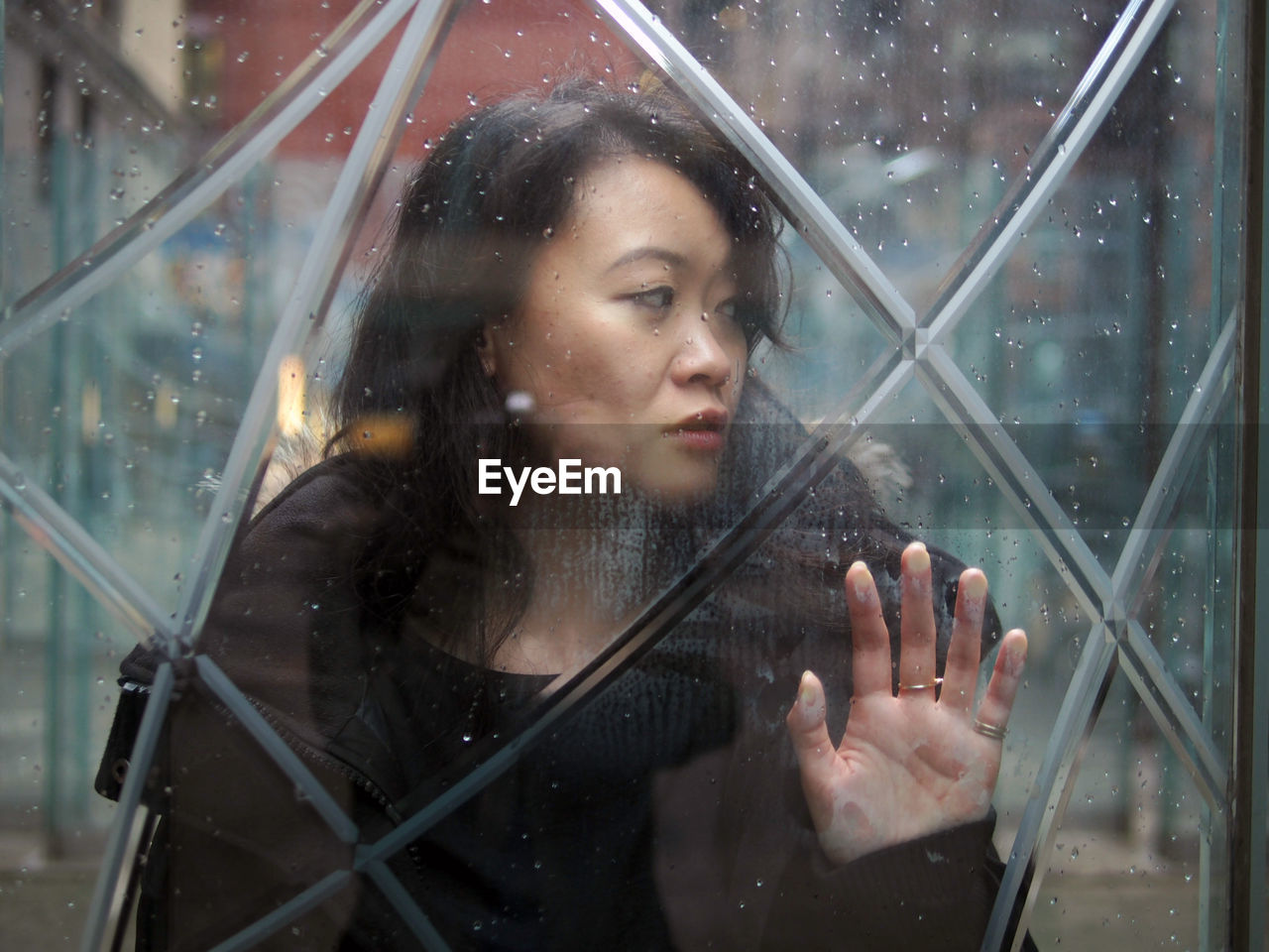 Woman looking through window