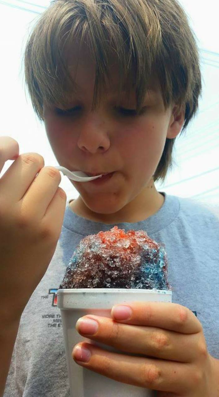 Close-up of boy eating snow cone