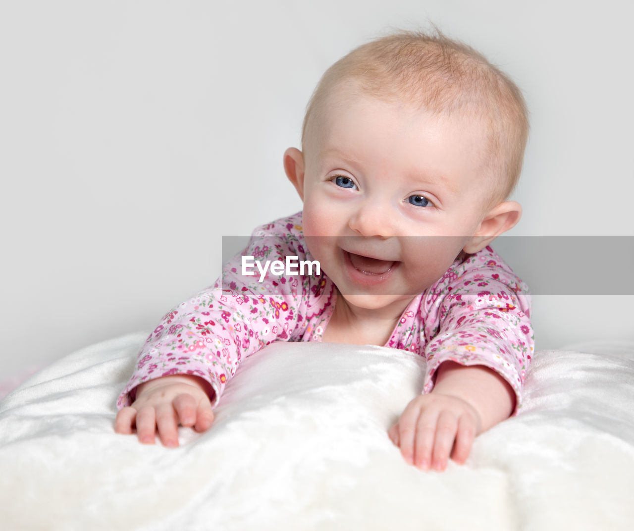 CLOSE-UP OF CUTE BABY ON BED