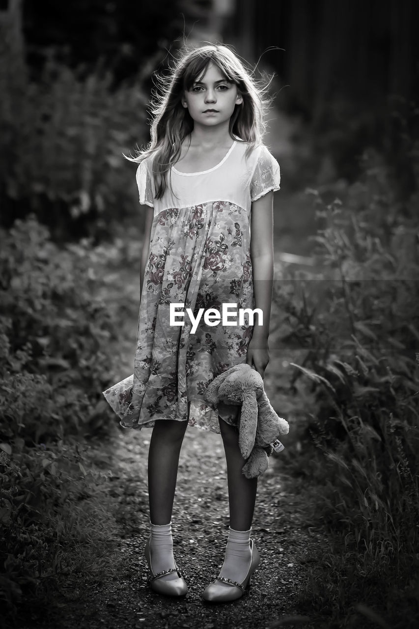 Portrait of a girl standing on field