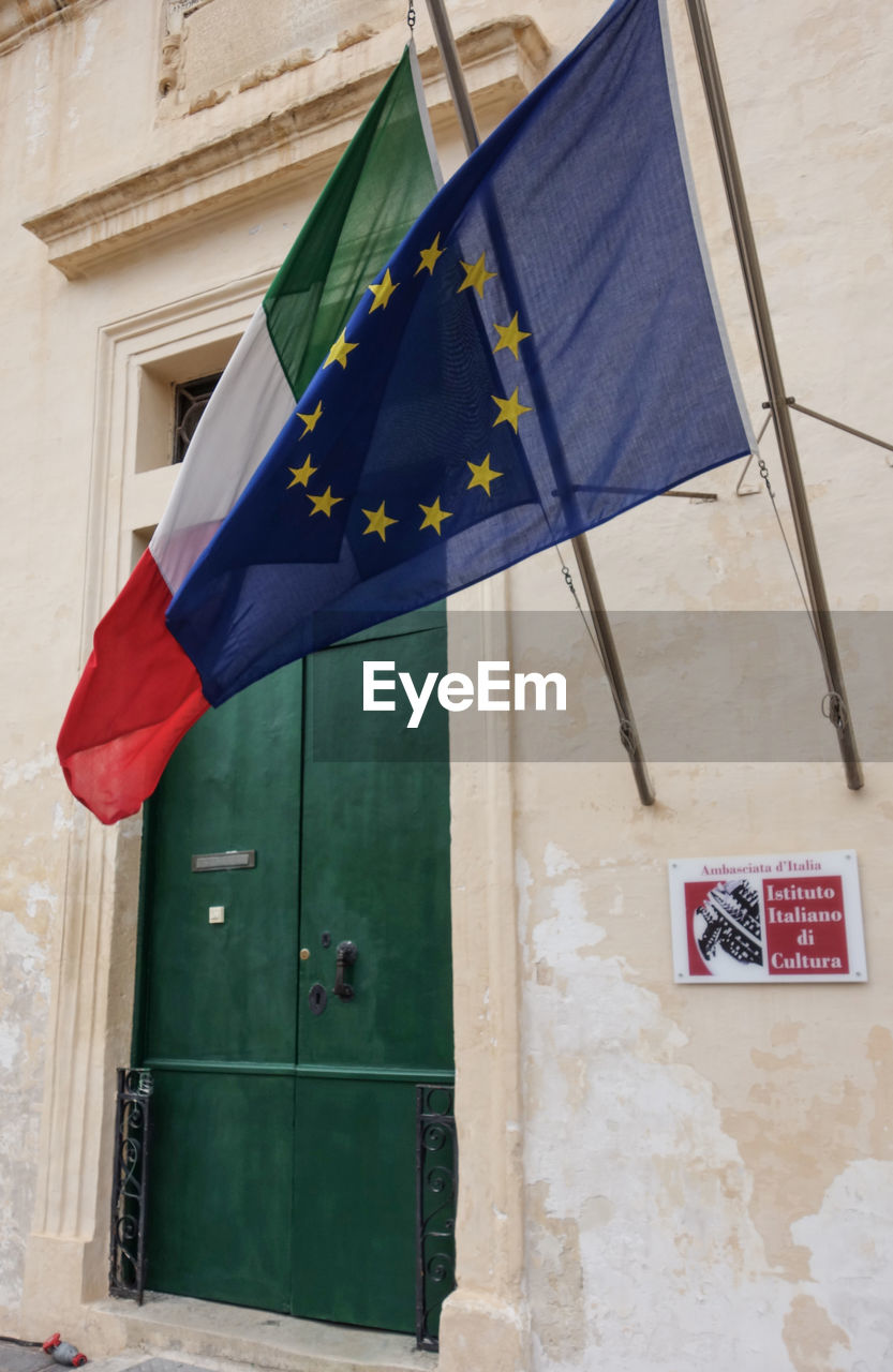 LOW ANGLE VIEW OF FLAG AGAINST BUILDING