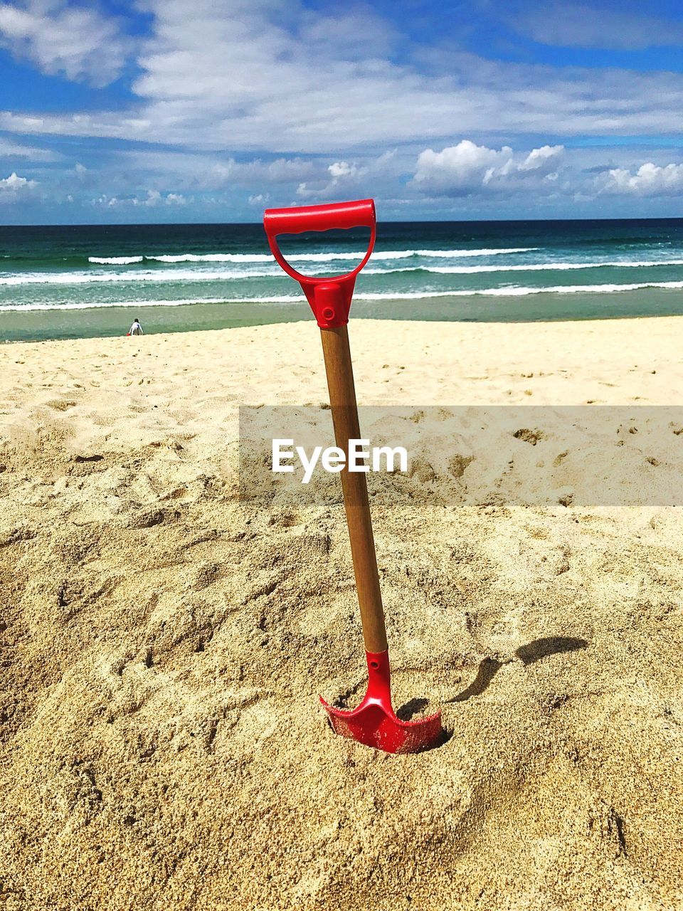 Red umbrella on beach against sky