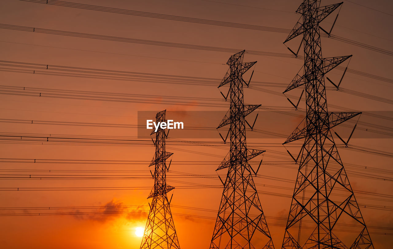 High voltage electric pylon and electrical wire with sunset sky. electricity poles. power and energy