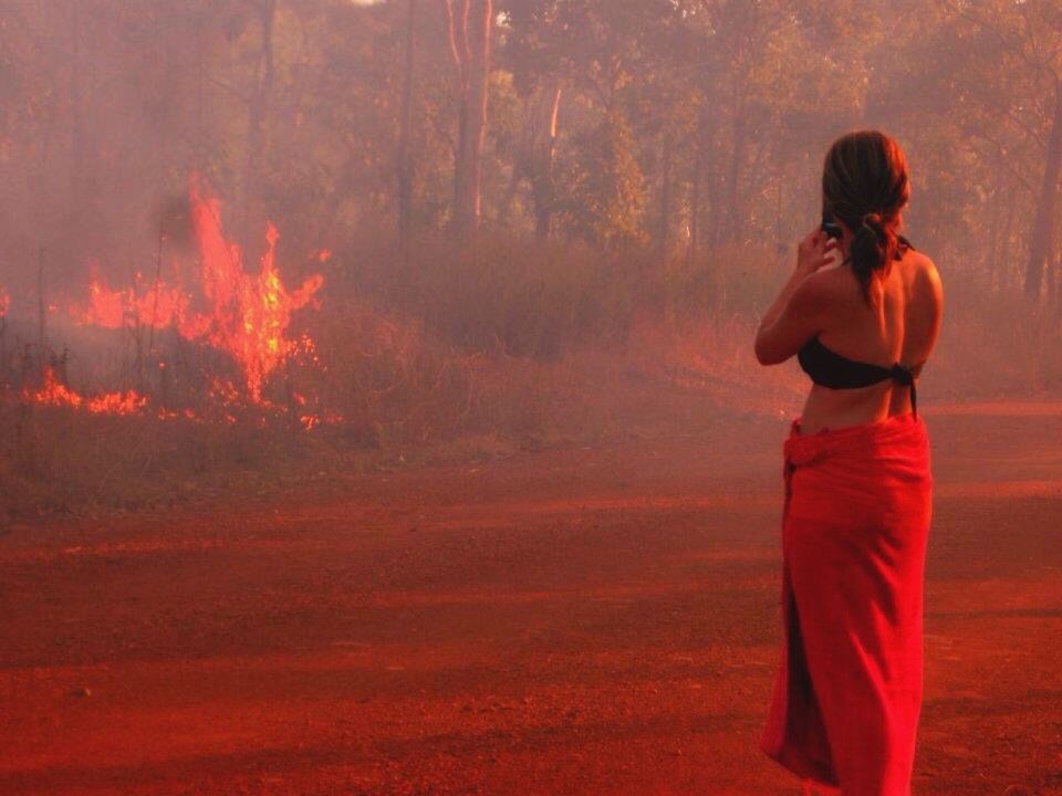 WOMAN STANDING AT SUNSET